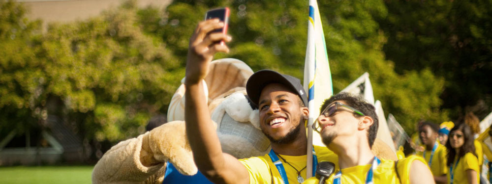 Ryerson students taking a selfie with Eggy, the University's mascot